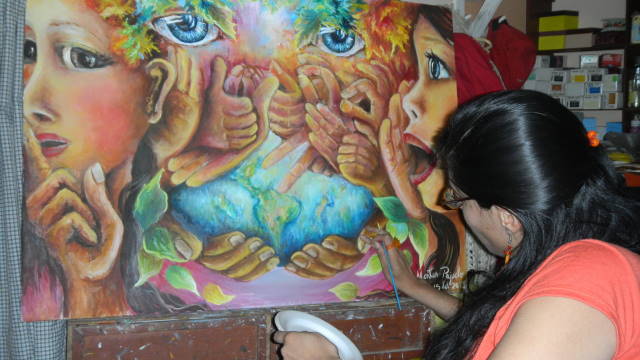 Juana Montes P painting a piece inspired by hearing loss, received a wheelchair from Purinapaq’s mission in Peru and her father received hearing aids
